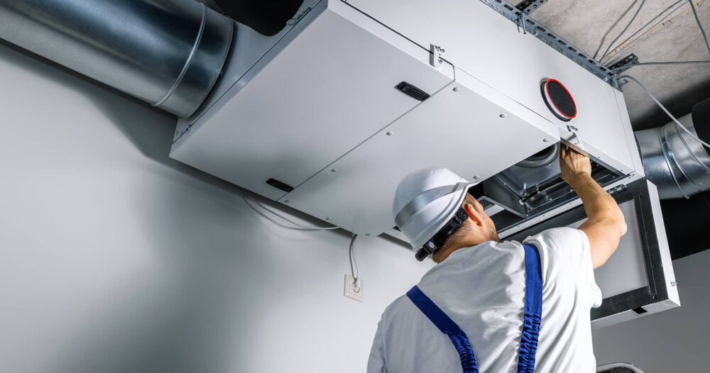 C1 featured image hvac tech inspecting a unit